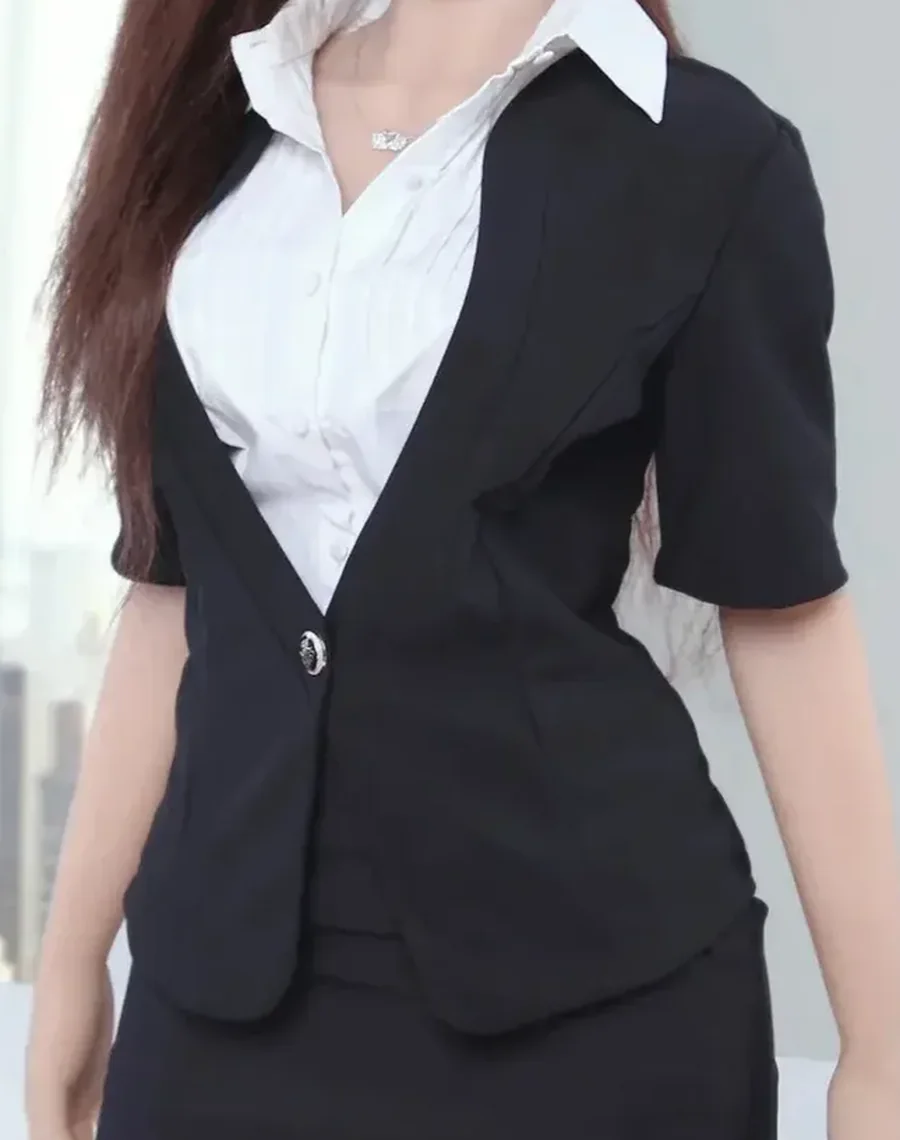 Torso of a realistic doll in a black suit jacket and white shirt