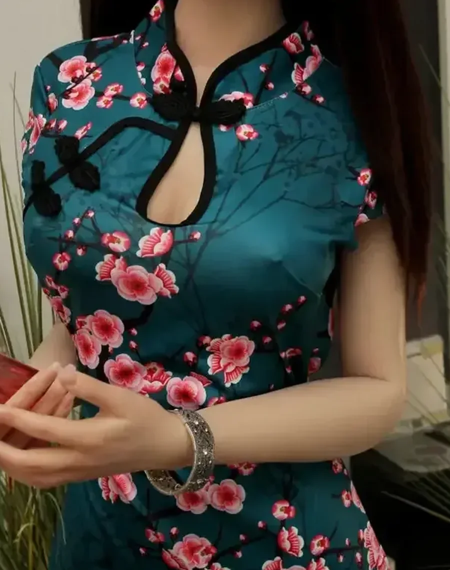 Realistic doll in a teal floral qipao, cropped at the torso from collar to hips