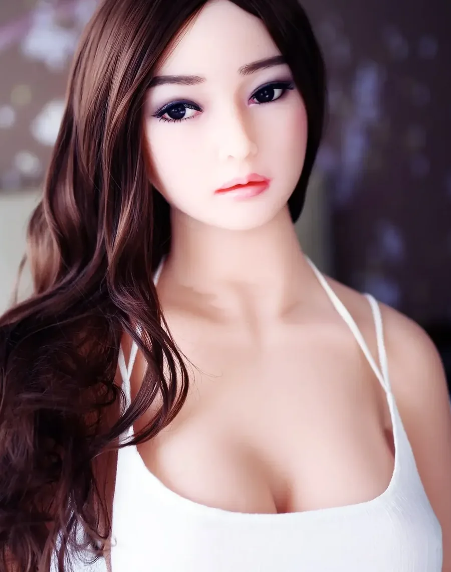Realistic doll with long dark wavy hair in a white top